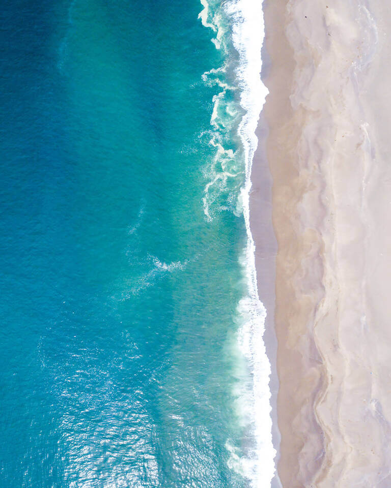Aerial View Of The Ocean Waves Washing On The Coast Of The Pacif