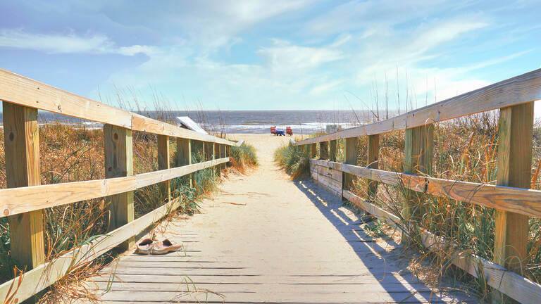 An Ocean View Down A Wooden Ramp To A Sandy Beach In Pastel Colo